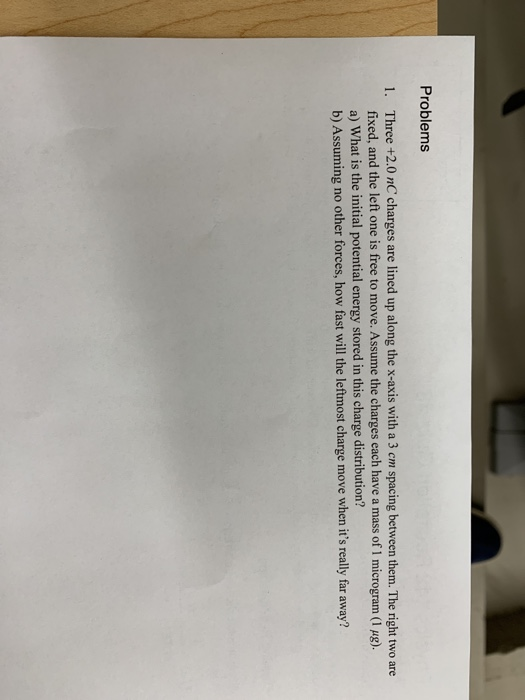 Solved Problems Three +2.0 nC charges are lined up along the | Chegg.com