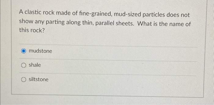 A clastic rock made of fine-grained, mud-sized particles does not show any parting along thin, parallel sheets. What is the n