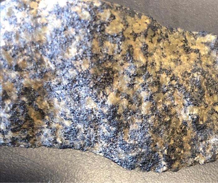 Solved has a lot of opaque minerals amd i think olivine and