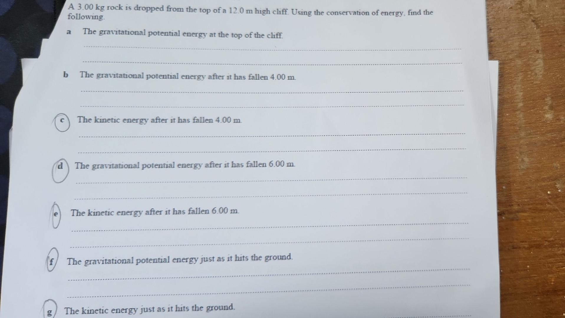 Solved A. 3.00 kg rock is dropped from the top of a 12.0 m | Chegg.com